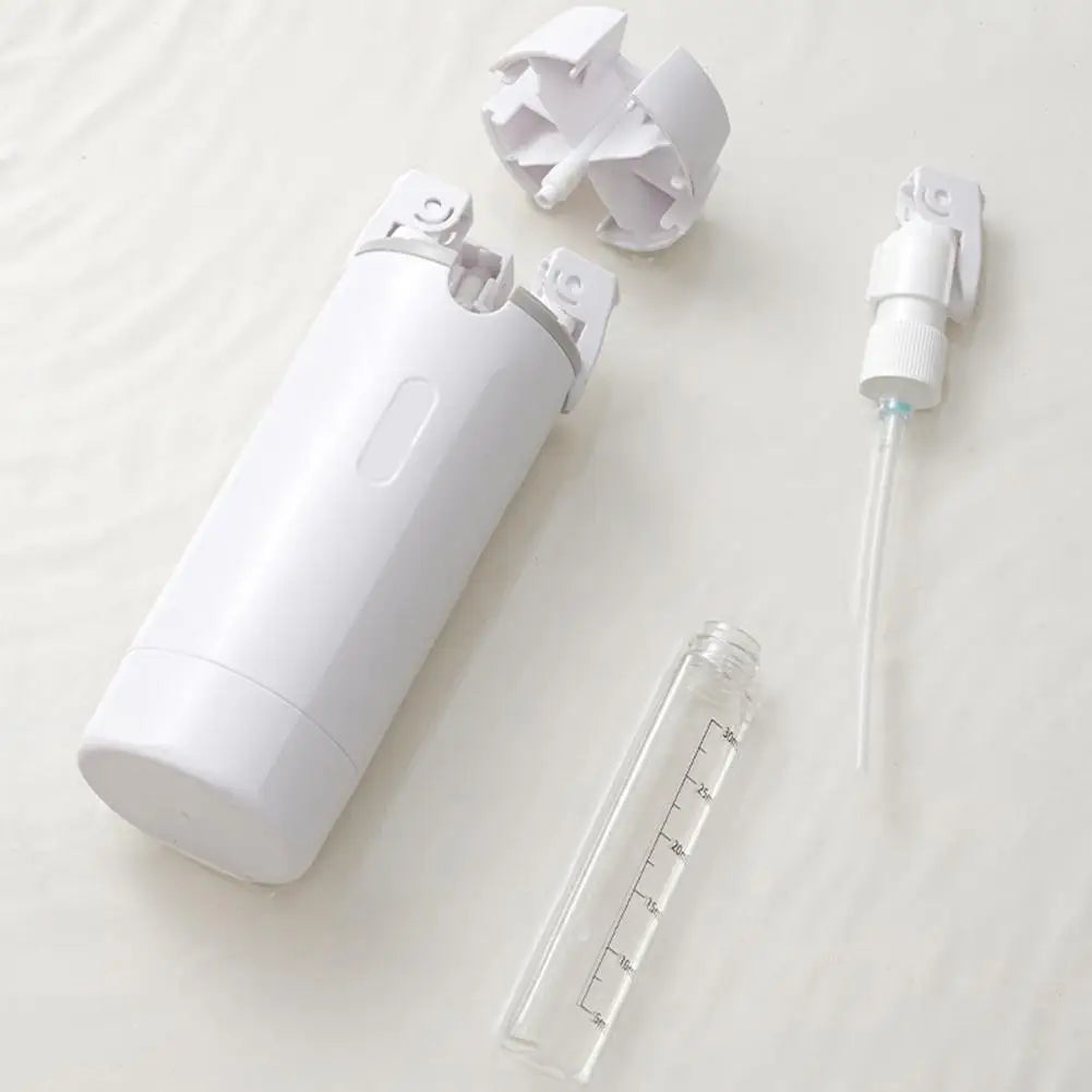QuadPod taken apart showing a refillable bottle and pump head